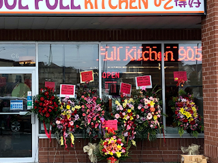 Exterior of eatery with large bouquet of flowers in front in Headford, Richmond Hill, Ontario